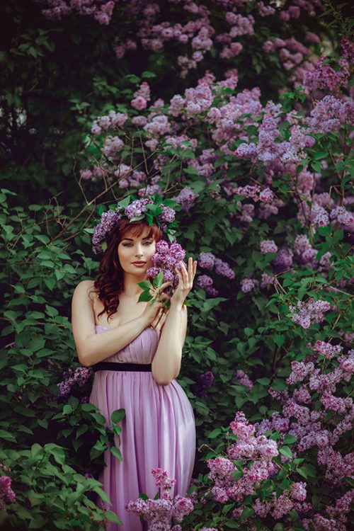 beautiful-girl-in-purple-dress-with-lilac-flowers-FPDYXV6.jpg